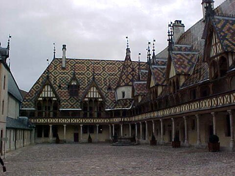 Hospices de Beaune rooftop with multicolored tiles.