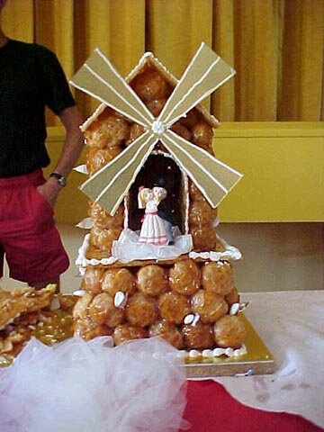 Photo of a French wedding cake made of cream-filled pastry puffs, covered in a caramel
